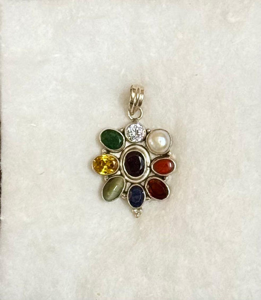 Multicolored gemstone pendant on a white background