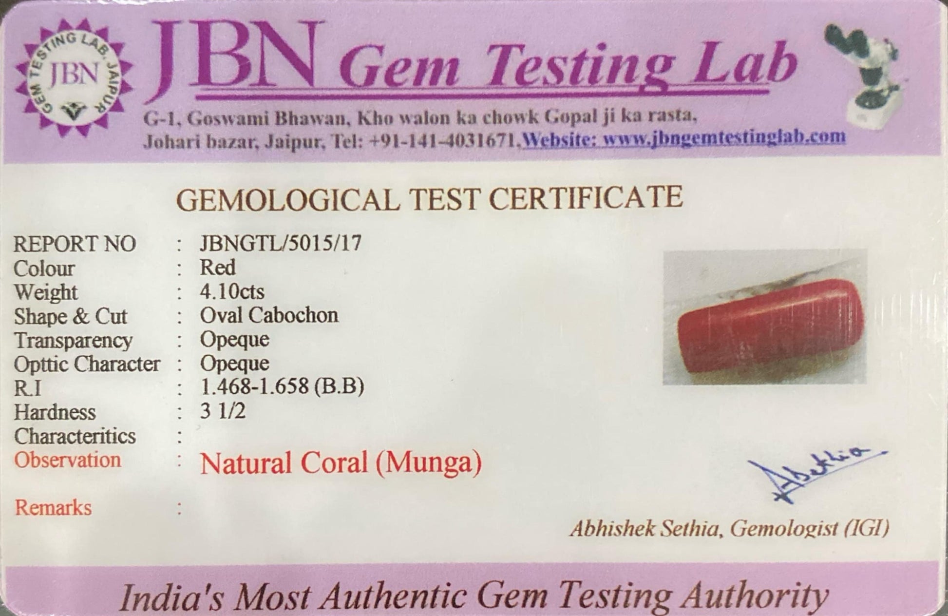 Gemological test certificate from JBN Gem Testing Lab with a red gemstone image.