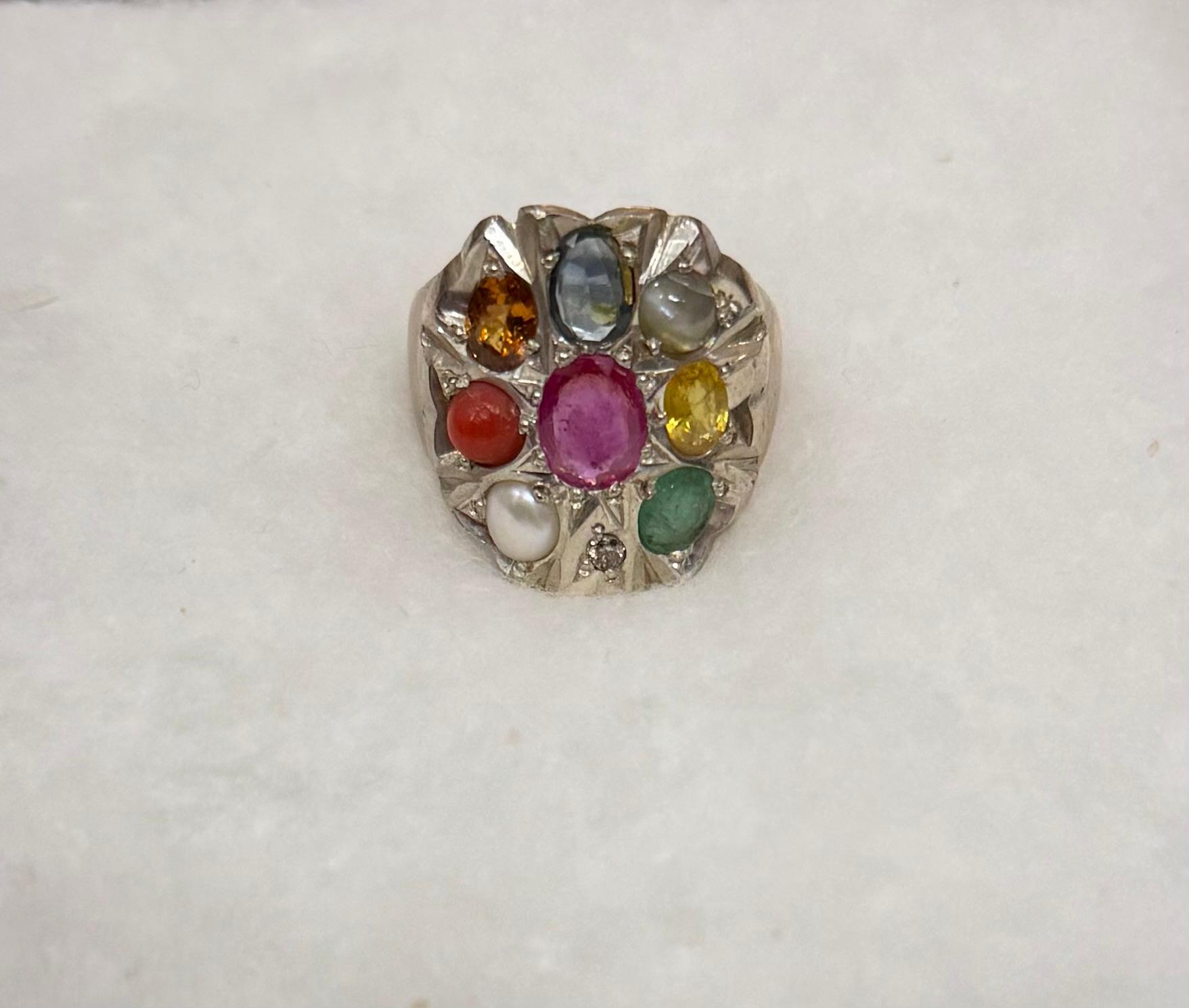 Ring with multicolored gemstones on a white background