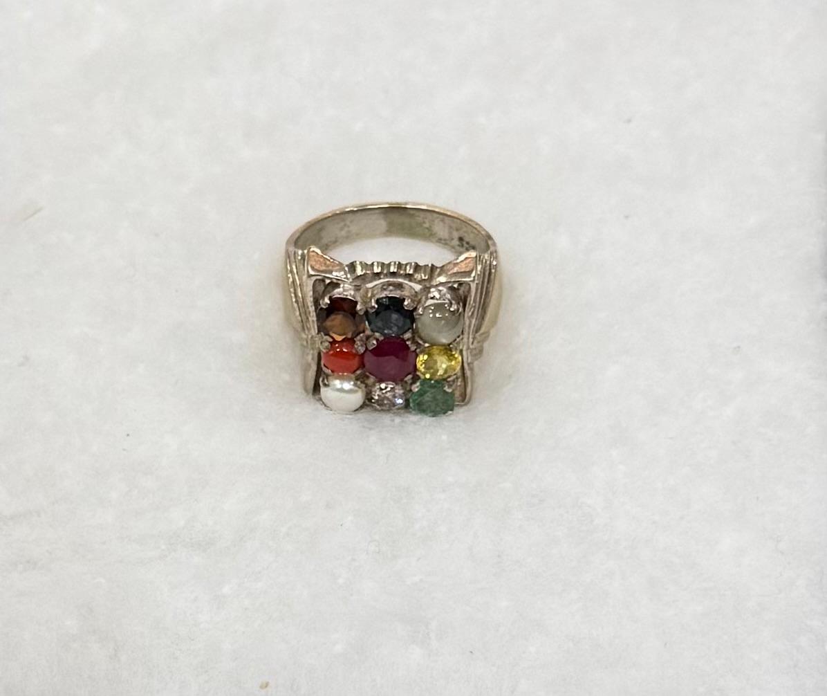 Silver ring with colorful gemstones on a white background
